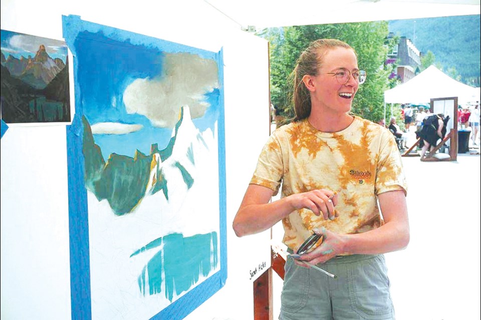 Painting a mural in one day was the goal but Sarah also took time to visit with those attending the Banff Art Walk.

