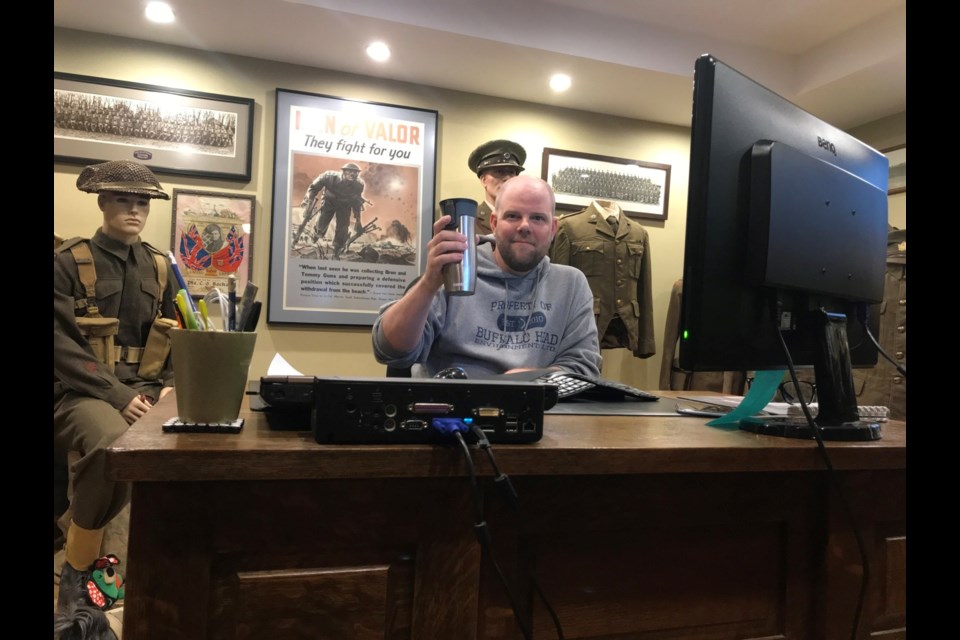 Scott Paton with his extensive collection of military memorabilia.