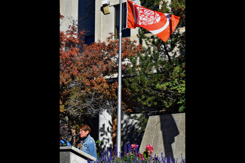 Central Urban Métis Federation Inc. President Shirley Isbister speaks as the Survivors' Fag waves elegantly after its raising on Monday, Sept. 26, at Civic Square.