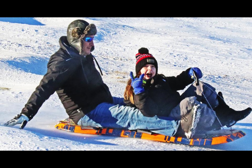 A sledder signalled her pleasure to the photographer as she flew down the hill on Saturday afternoon.
