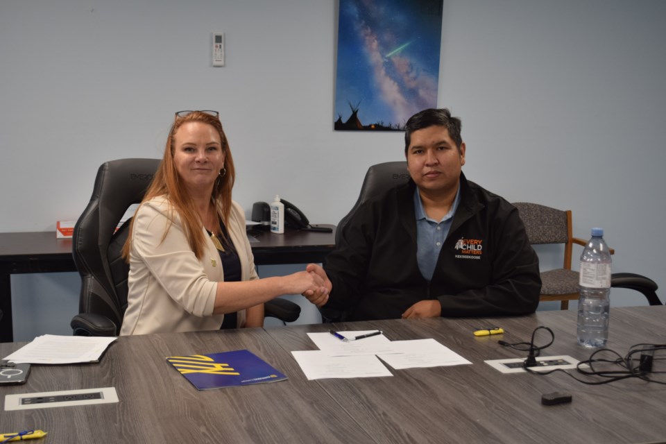 From left, Suncrest CEO and President, Alison Dubreuil shakes hands with Chief Alvin Musqua of Keeseekoose First Nation after having signed the paperwork on Oct. 7 to continue work on the smart farm project.