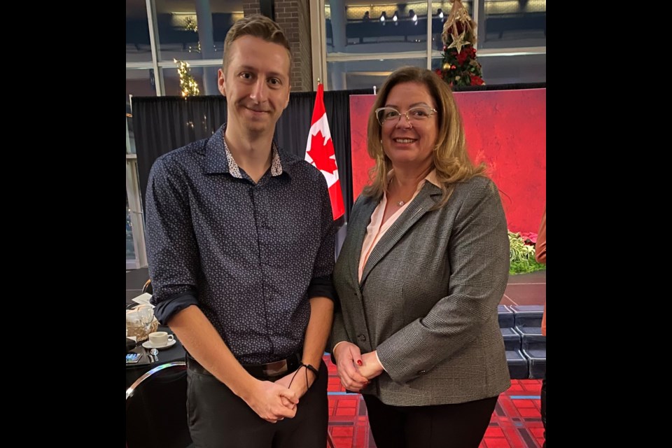 Tate Wrubleski, left, accepts his Premier’s Award from Estevan MLA Lori Carr. 