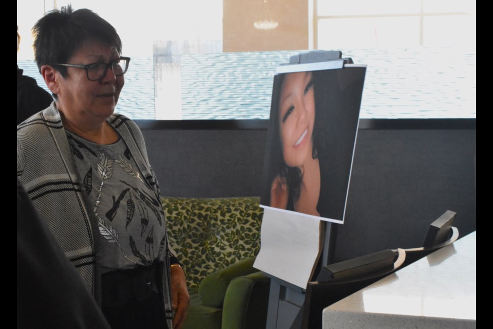 A relative of Taya Sinclair gets emotional as she looks at the photos displayed at the Holiday Inn lounge.