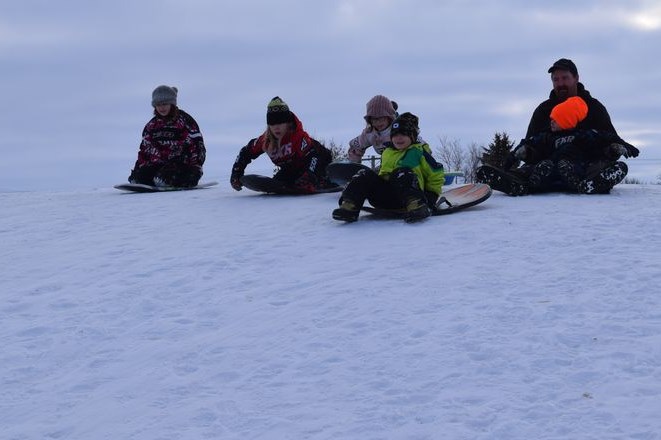 After a lengthy stretch of bone-chilling cold weather, John Johnstone and his five children headed out to enjoy the warmer temperatures and fast conditions last weekend on Canora’s Community Hill. While having fun is always the main goal, of course it’s also important to win family bragging rights and be the first down the hill. From left, were: Anallah, Nixon, Mykelti, Brecken in the early lead, and John on a sled with Kohen. / Rocky Neufeld