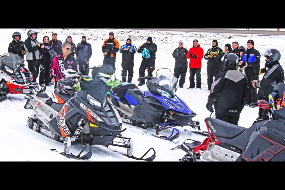The members of the Souris River Snowmobiling Club applauded Janette Tonn as she left the group before they began their ride in tribute to her late husband Gordon, a longtime member of the club.