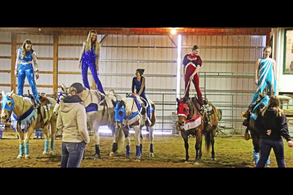 The Truco Trick Riders practised standing on their horse before doing it while the horse is running. From left are Charlize Hallberg, Jordanna White, Kyla Dyer (seated), Bailey Steeves and Shayda King. Guest coaches in front are Cashlyn Krecklau and Marcie LeBlanc, formerly of the Calamity Cowgirls trick riders of Estevan.