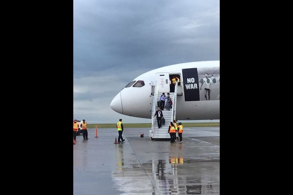 The first passengers leave the plane after the the humanitarian flight with 230 Ukrainians on board landed in Regina. 