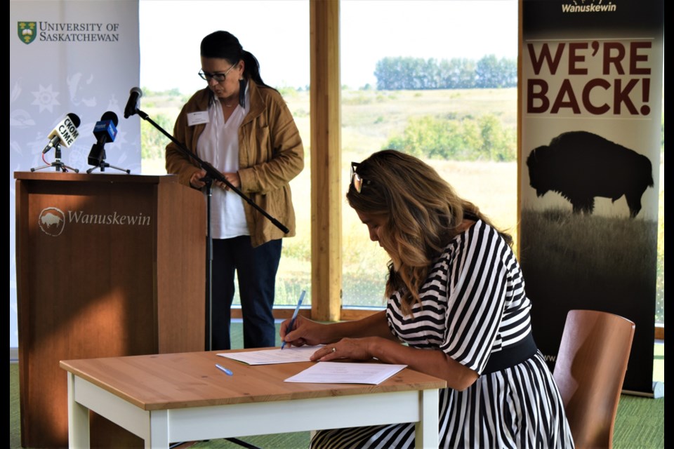 Wanuskewin Heritage Park CEO Darlene Brander, right, signs the MOU with University of Saskatchewan last summer.