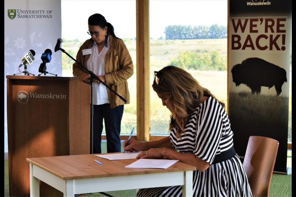 Wanuskewin Heritage Park CEO Darlene Brander, right, signs the MOU on Wednesday at the WHP visitor centre.