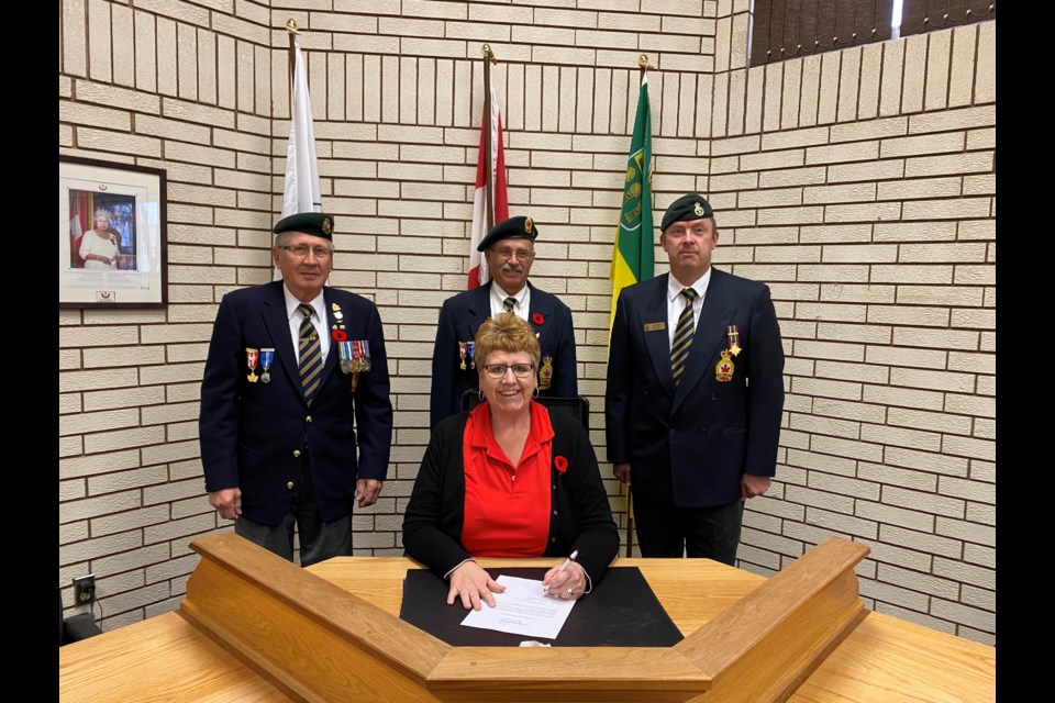Mayor Sharon Schauenberg signed a proclamation declaring the week of November 5-11 as 
Veterans Week in the Town of Assiniboia. Attending the proclamation, in the back row from left, were Legion members Irvin Tubbs (Branch 17 Legion veteran), Robert Sinclair (Branch 17, associate) and Kris Olson, (Branch 17, Legion veteran).