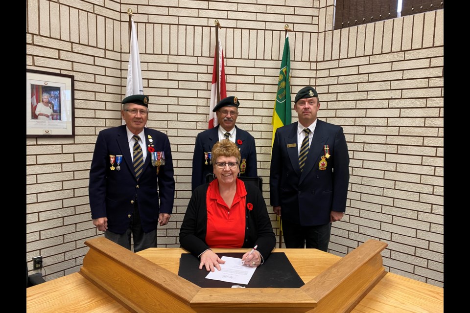 Mayor Sharon Schauenberg signed a proclamation declaring the week of November 5-11 as 
Veterans Week in the Town of Assiniboia. Attending the proclamation, in the back row from left, were Legion members Irvin Tubbs (Branch 17 Legion veteran), Robert Sinclair (Branch 17, associate) and Kris Olson, (Branch 17, Legion veteran).