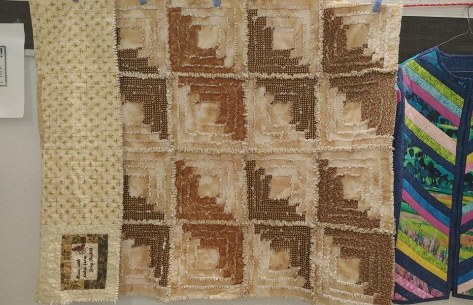 Using fabrics that belonged to fellow quilter, Judy Boskill, a quilt was hung in her memory.