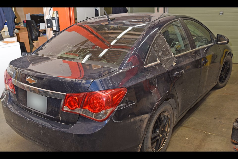 A firearm was discharged from this dark blue 2011 Chevrolet Cruze. A police vehicle was hit.