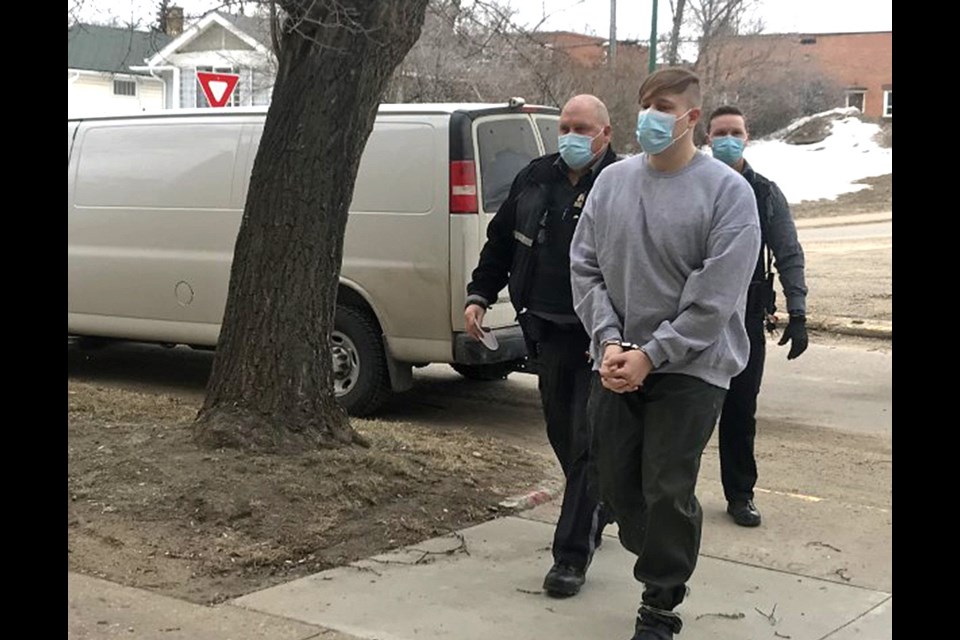 Nathaniel Carrier is brought into Prince Albert Court of Queen's Bench Wednesday. He killed his son and parents and tried to kill his daughter in March 2020. 