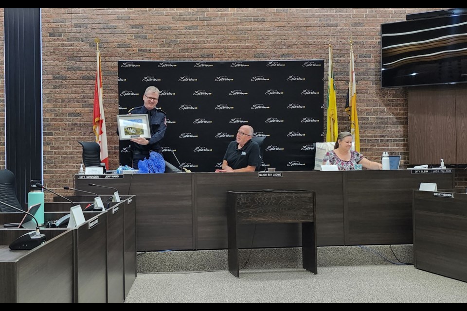Estevan's current Police Chief Richard Lowen was presented with a picture of the Estevan water tower ahead of his departure. 