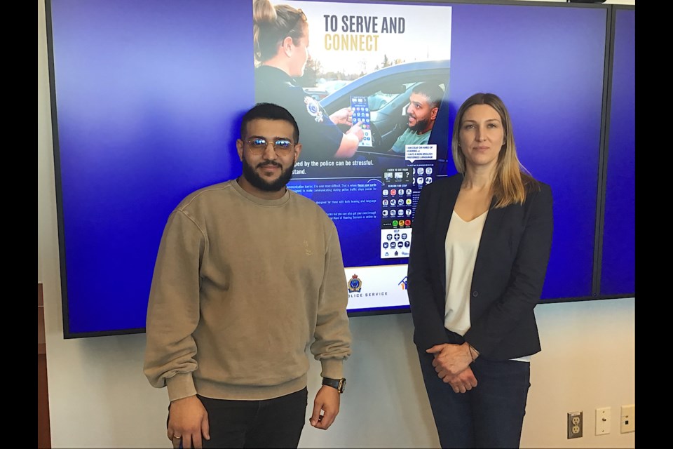 Mustafa Alabssi and Cst. Erin Black at the launch of communications cards aimed at helping interactions between the police and those who are deaf or hard of hearing or whose first language is not English.