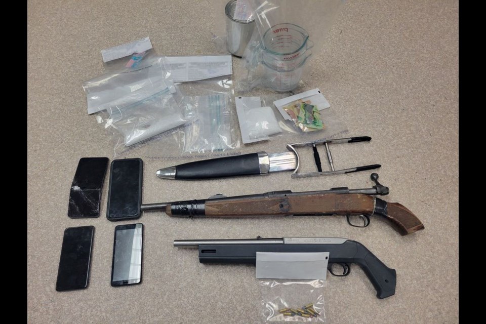 Police located 51 grams of fentanyl, 138 grams of an unknown substance, 13 grams methamphetamine, a sawed-off rifle, a rifle, ammunition, and other drug trafficking paraphernalia in the house fire.