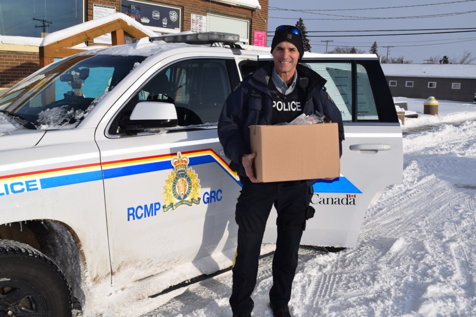 Cpl. Mike Rosset of the Canora RCMP detachment stopped at Filling the Gap Food Bank in Canora to help with Christmas hamper deliveries on Dec. 15. Rosset said he had helped out at food banks in other communities where he has worked, and was eager to serve the community in a similar way in Canora. 