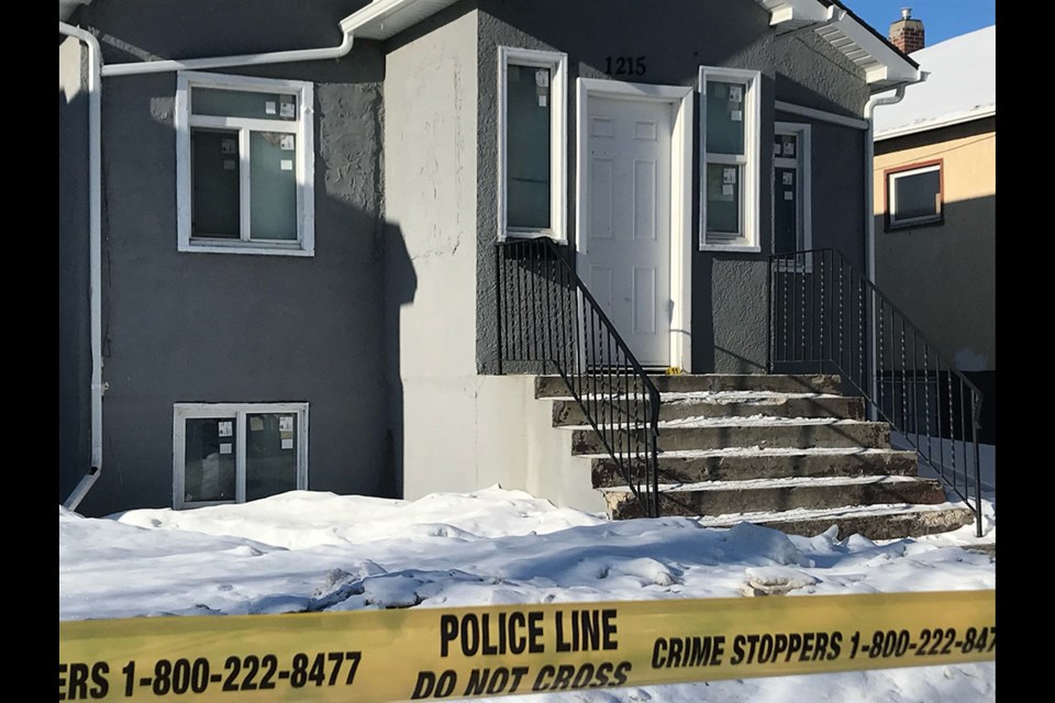 Crime scene investigators have placed a yellow marker with the number 11 in front of the door of this house.