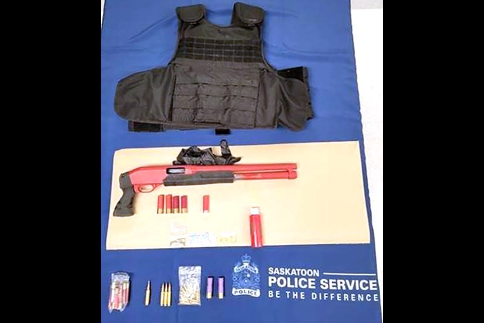 Police seized tactical body armour,  a loaded sawed-off shotgun, various ammunition, and a small quantity of crystal meth.