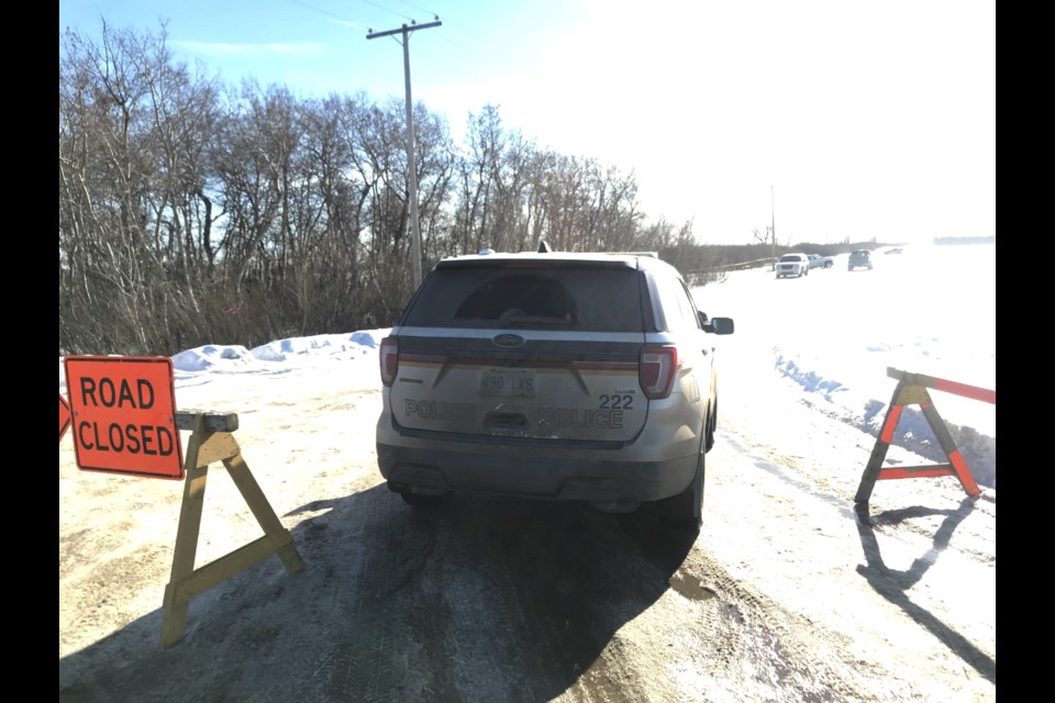 Police cordoned off a side road that leads to a field off of 11 Street in Saskatoon and remain at the scene Tuesday afternoon.
