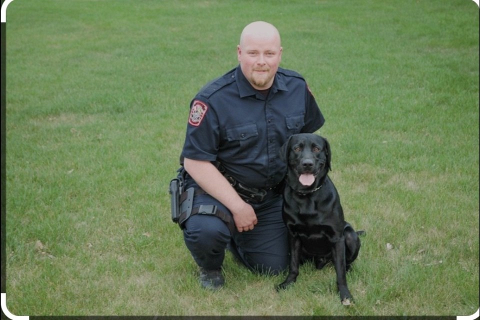 Sgt. Tyler McMillen is pictured here in his younger days with police service dog Harvey. 