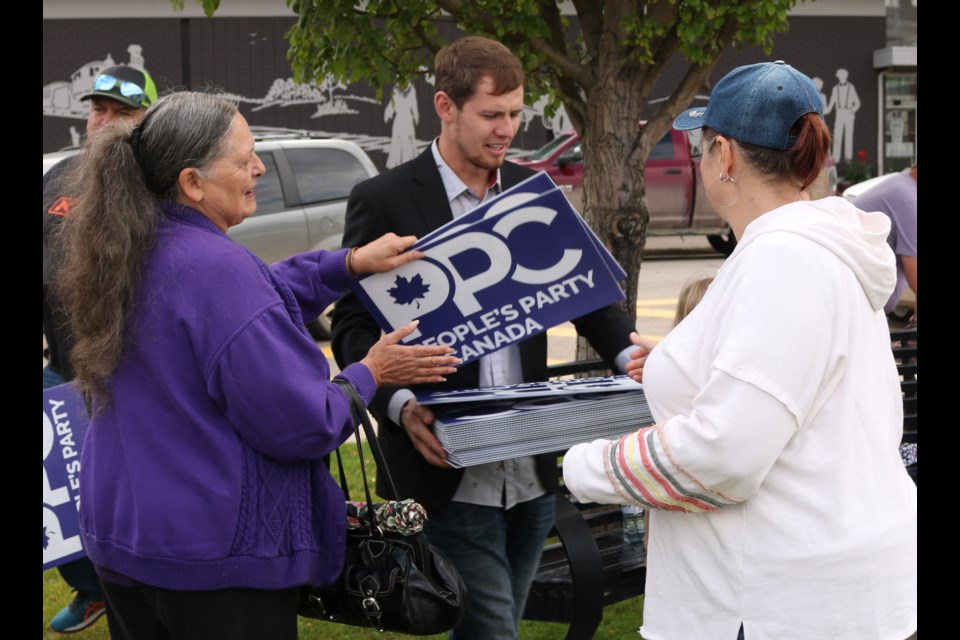 Yorkton-Melville PPC candidate Braden Robertson, centre, hands out signs Saturday in Yorkton.