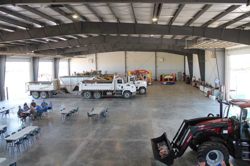 Three graders, two trucks, one tractor and still lots of room left to work. 
