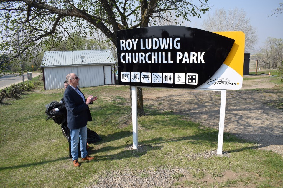 Roy Ludwig applauds as the sign is revealed. 