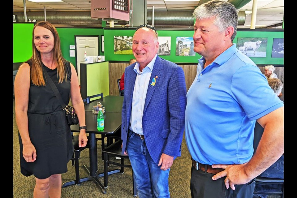 Monica Osborn, executive director of the Weyburn Chamber of Commerce, chatted after lunch with Souris-Moose Mountain MP Dr. Robert Kitchen, and visitor MP Scott Aitchison, who is one of the candidates for the leadership of the federal Conservatives, on Friday.