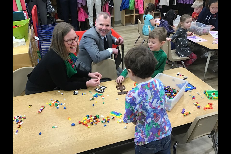 Federal minister Karina Gould and provincial minister Dustin Duncan join in the fun with kids at the YMCA childcare in Regina.
