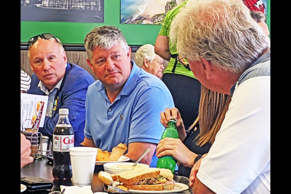 MP Scott Aitchison, centre, listened along with Souris-Moose Mountain MP Dr. Robert Kitchen (left) as he had lunch at the Welsh Kitchen on Friday in Weyburn.