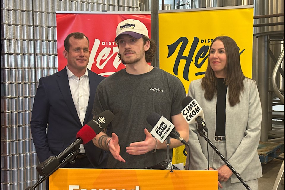 District Brewing marketing coordinator Hayden McPherson flanked by Trent Wotherspoon and Aleana Young at announcement.