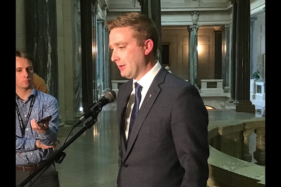 Education Minister Jeremy Cockrill speaks to reporters May 13.