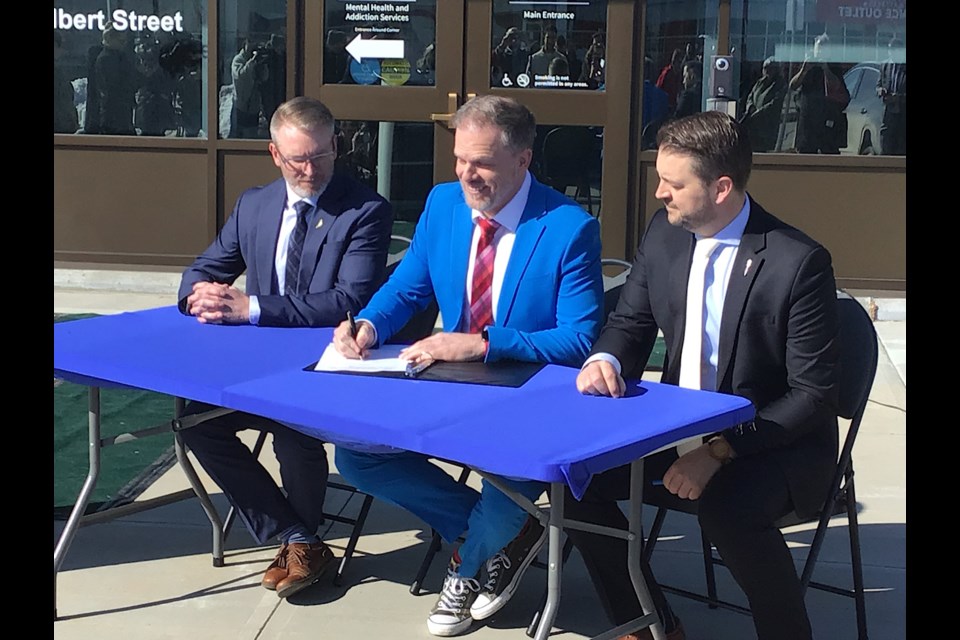 Ministers Everett Hindley, Mark Holland and Tim McLeod sign the health care bilateral agreements.