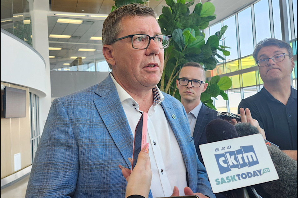 Premier Scott Moe speaks to reporters at Saskatoon 
John G Diefenbaker International Airport.