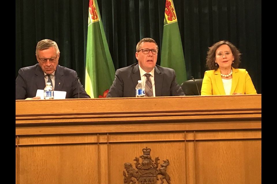 At the podium, left to right, SaskPower Minister Don Morgan, Premier Scott Moe, and Minister of Justice and Attorney General Bronwyn Eyre.