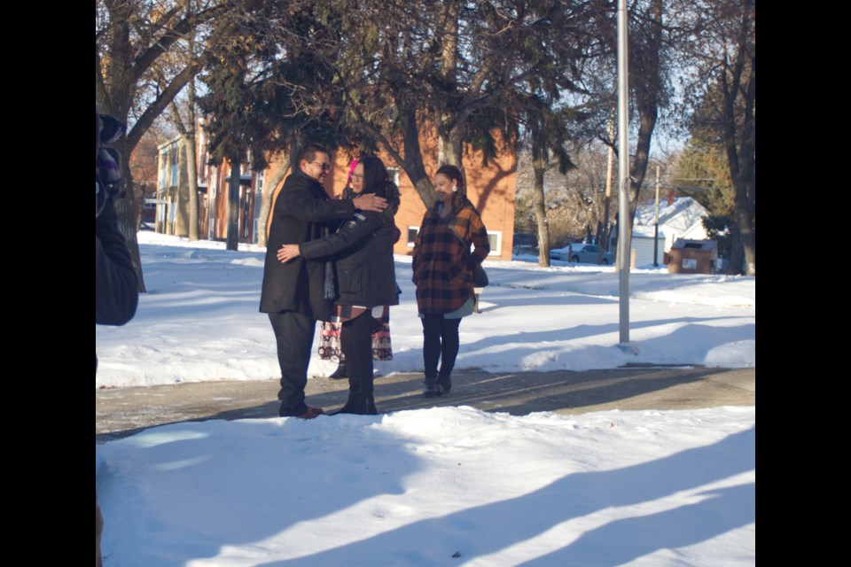 Keeseekoose First Nation Chief Lee Ketchemonia embraces Odelia Quewezance moments prior to her reunion with sister Nerissa Quewezance. The sisters had not seen each other in 18 years until the Nov. 24 publication ban hearing in Yorkton.