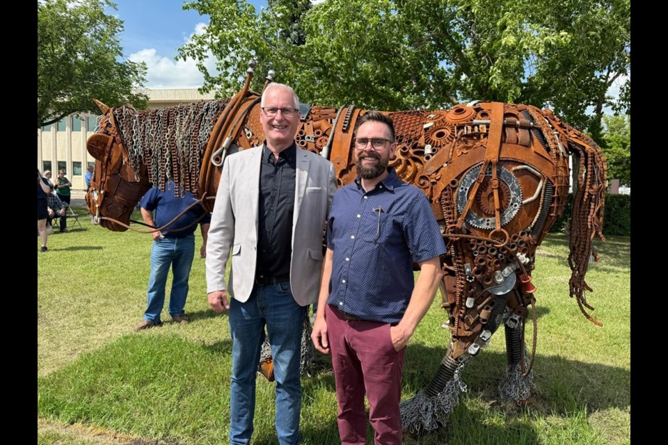 Mayor Rob Muench and local artist Tyler Dies in front of the new unveiled Iron Triangle sculpture.