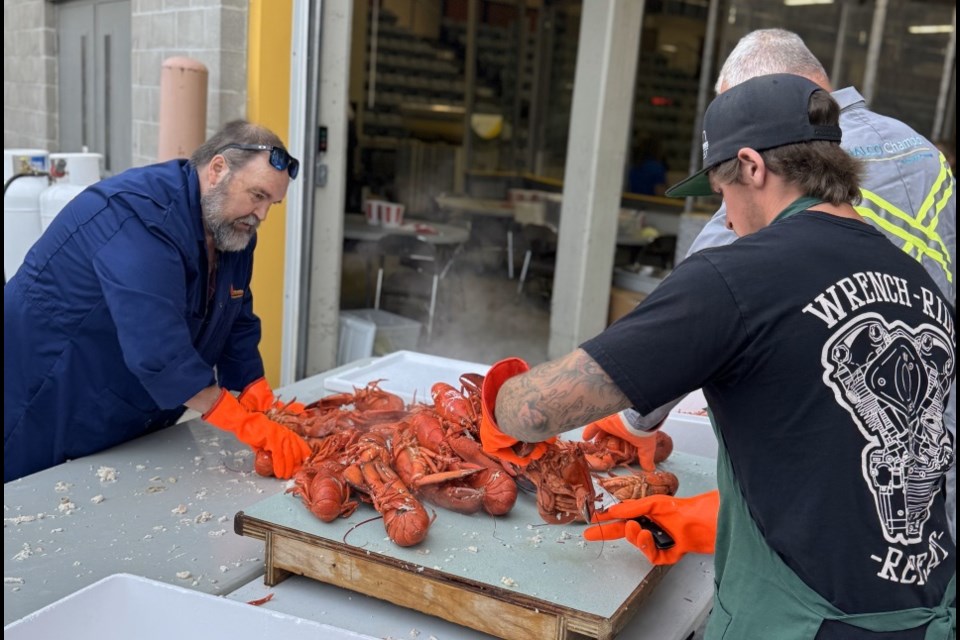 A crew prepared lobster for the event.