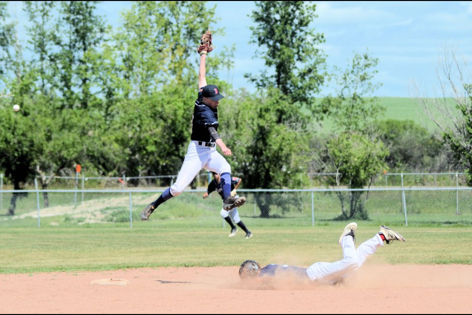 SWNA winning photo, featuring an U22 provincial baseball championship game between North Battleford and Unity, held in Unity July 23. 2nd baseman is North Battleford's Skyler Dimmick and sliding to base is Carter Johnson.  