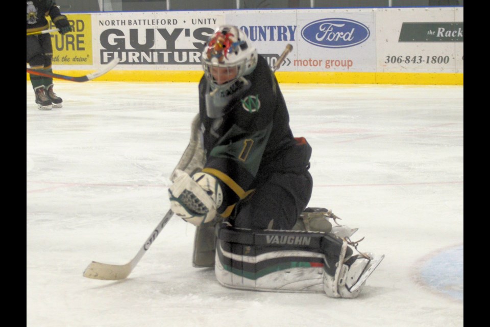 Wilkie Outlaws’ goalie Jared Herle makes a glove save in the Wilkie Outlaws Dec. 5 home game against the Edam 3 Stars. Herle made 29 saves on 32 shots in the 9-3 win against the 3 Stars. 