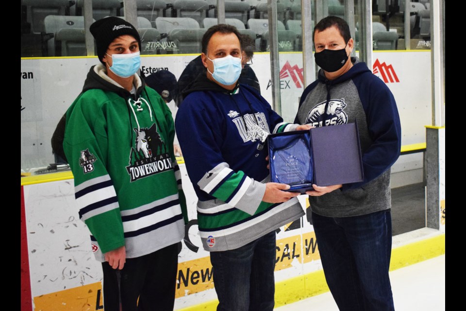 Burt Blondeau, left, made a presentation to Jordan Lavoie and Gary Lavoie. 