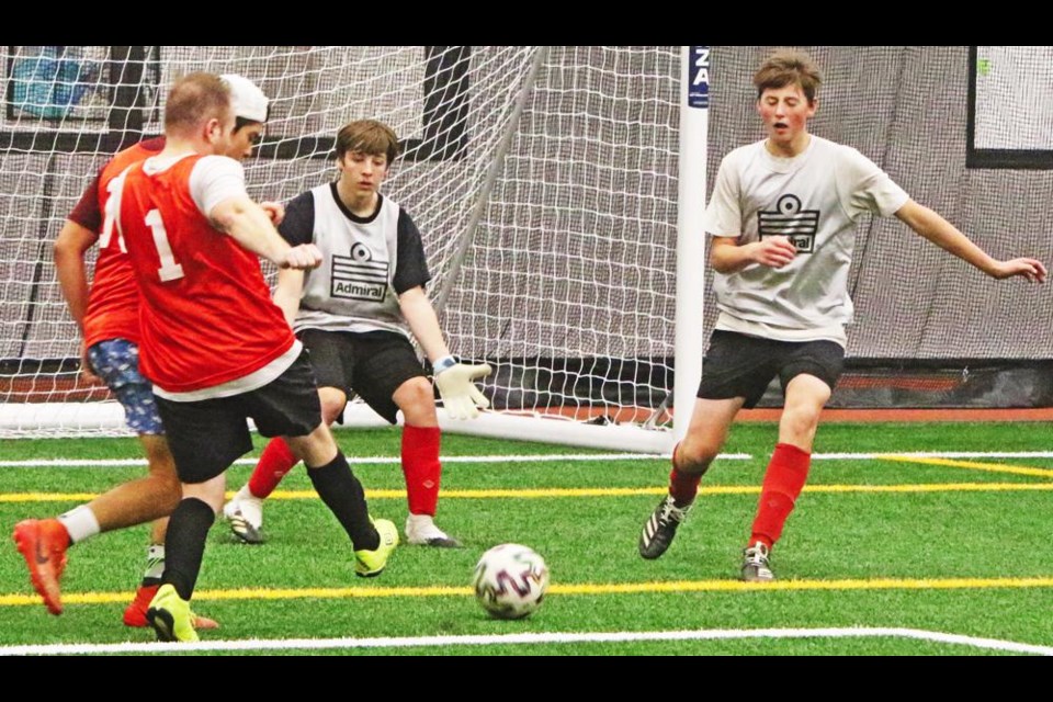 A player makes an attempt to score during the adult rec soccer league held on Tuesday evenings at the CU Spark Centre.