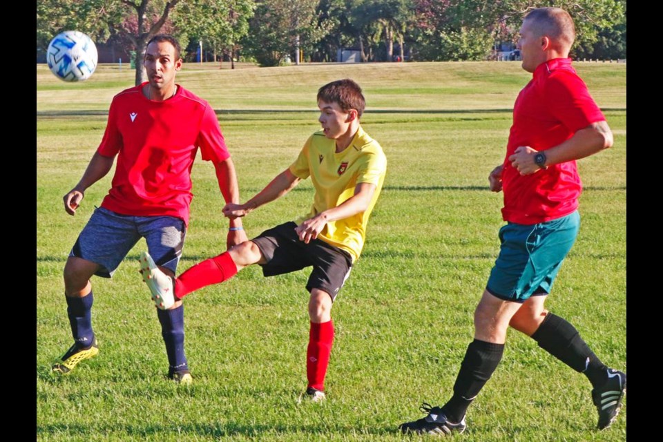 A U17 Devils player gave the ball a big kick to get the ball down towards the net, in Weyburn adult soccer action on Tuesday night.