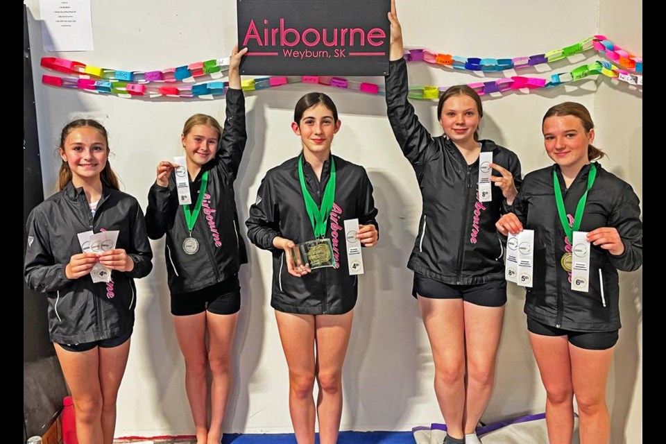 Airbourne gymnasts show their ribbons and trophies, from left to right, CCP4s Avery Fleck, Eliza Gall, all-round provincial champ Sophie Pollock, Xcel Gold Rachel Keller, and CCP4 Mackenzie Pulfer.