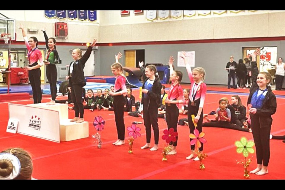 Weyburn Airbourne gymnasts (in the pink tops) Isabelle Cugnet, left, received her award as second All Around, while teammates Brynn Huebner was fourth, and Kam Dammann and Lexi Heimlick were in a three-way tie for fifth in the CCP Level 3 category. They competed in Moose Jaw over the weekend at the last meet of the season.