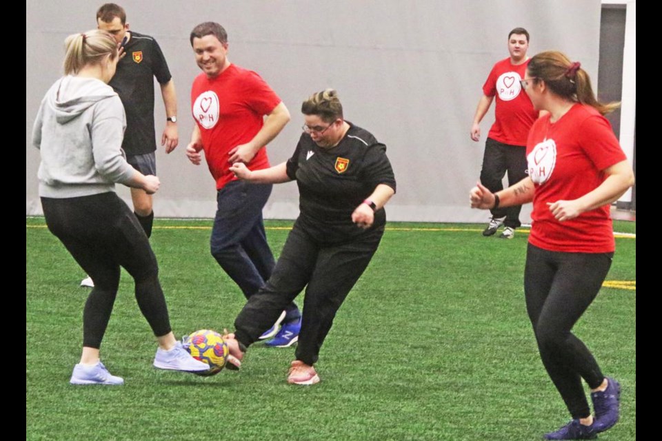 Morgan Scharnatta, in grey, of the Paramedics With Heart team, went up against Robin Stelter of the All Abilities team, in a fun soccer game on Thursday evening at Weyburn's Credit Union Spark Centre. In red are Joel Rogers and Rikki Miller of the Paramedics team