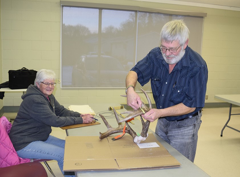 With his wife Dianne recording the results, Floyd Hendrickson of Margo measured a set of white-tailed deer antlers at the River Ridge Fish & Game League antler measuring held on Dec. 8 at the Canora Golf Course Activity Centre.