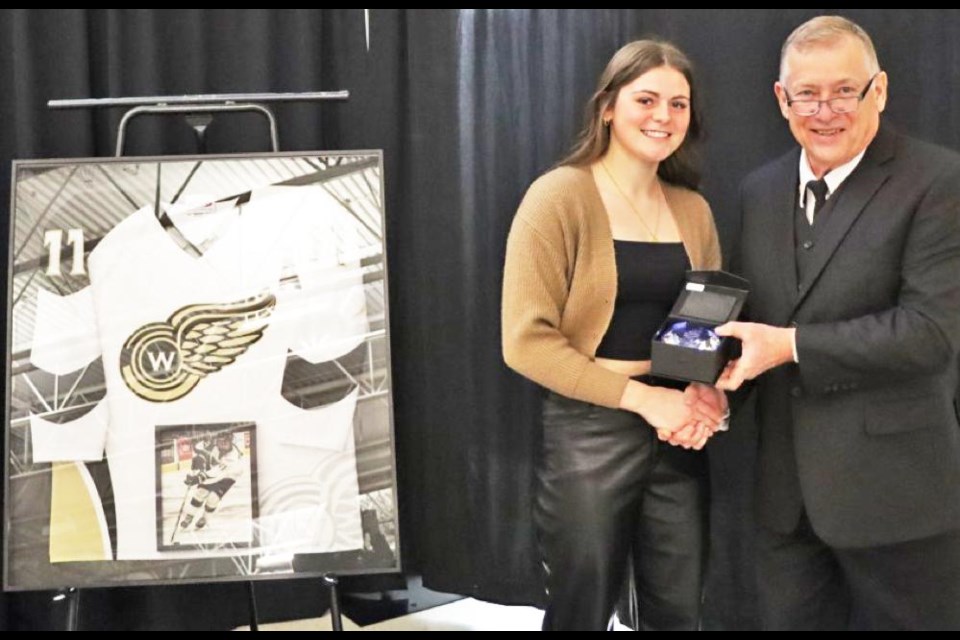 Ashton Bender, a forward with the Richardson Pioneer Weyburn Gold Wings team, was honoured with an induction in her home town of Moosomin, to the Mike Schwean Arena’s Wall of Fame. Here she was presented with a plaque in a ceremony on Dec. 23 by town councillor Greg Nosterud. 